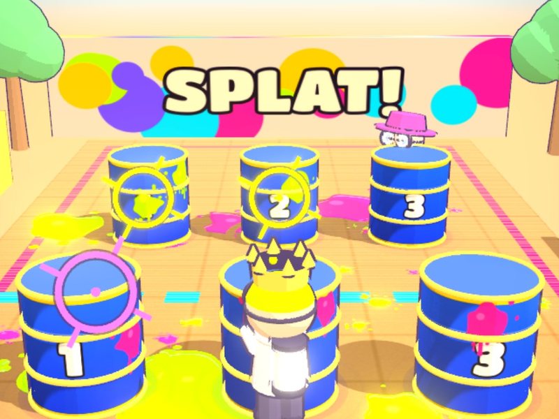Standoff: two paintball players behind blue barrels, aim markers locked on, ink splattered across a skate park